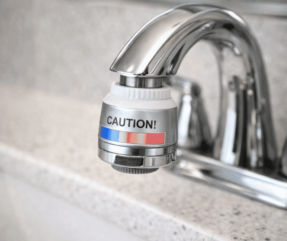 Kitchen faucet with anti-scald temperature indicator attachment to help prevent hot water burns.